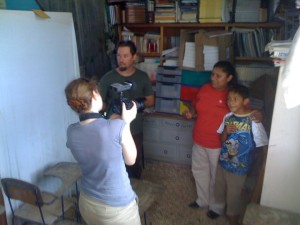 CFACT volunteer Jason Lively translates and Sarah Cowles shoots video as Abelia Lopez, shown with one of her three sons, expresses her appreciation to CFACT on behalf of the 40 students at her tiny school in Valle Verde. [Photo by Scott Evans Andrews.]